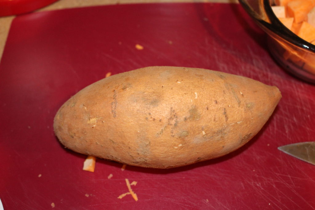 A whole sweet potato unpeeled perfect for oven roasted potato recipe